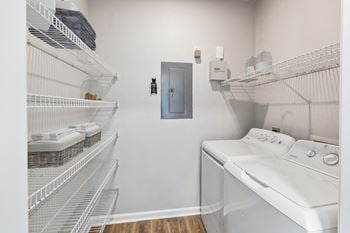 A laundry room with a washer and dryer and a door